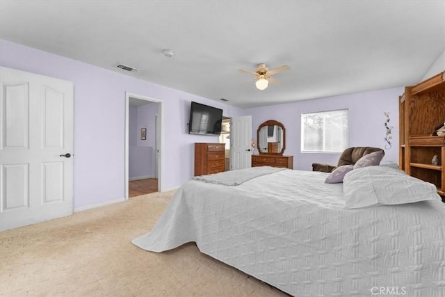 bedroom featuring baseboards, carpet, visible vents, and ceiling fan