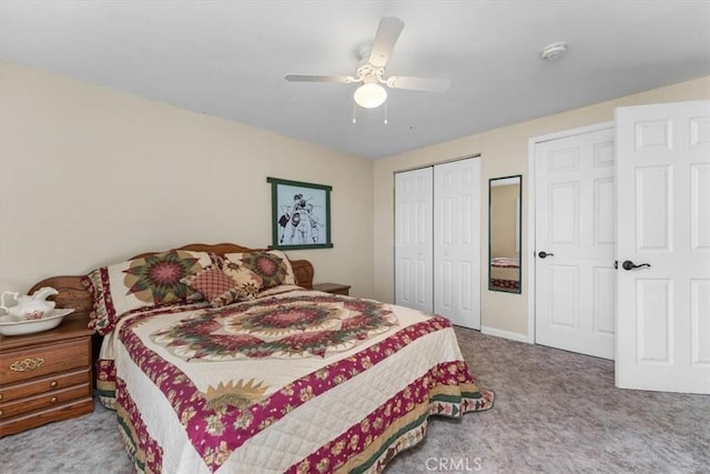 carpeted bedroom with a closet, baseboards, and a ceiling fan