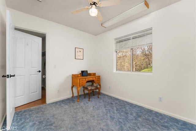 home office with carpet flooring, a ceiling fan, and baseboards