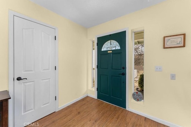 foyer featuring wood finished floors and baseboards