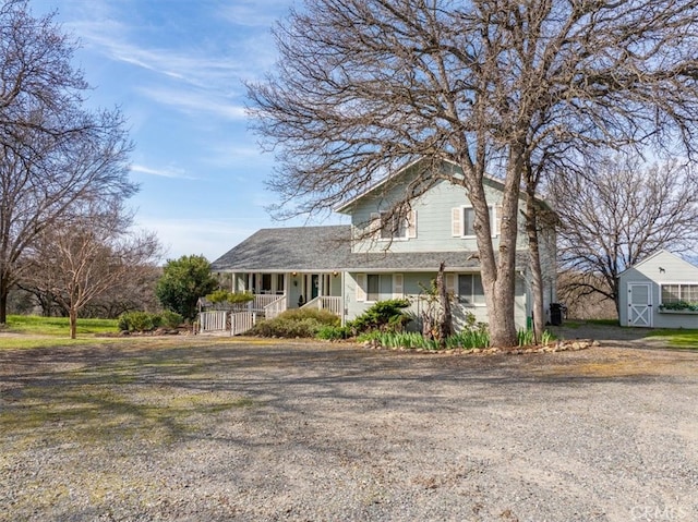 view of front facade with an outbuilding and a porch