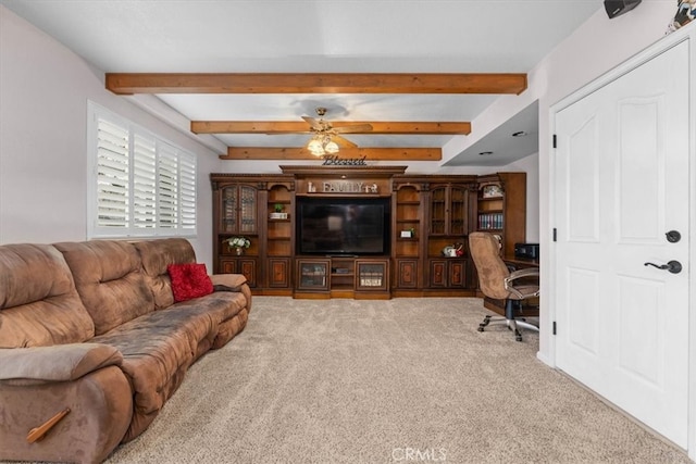 carpeted living room with beamed ceiling