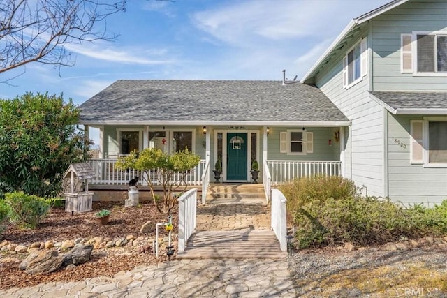 view of front of home featuring a porch and a shingled roof