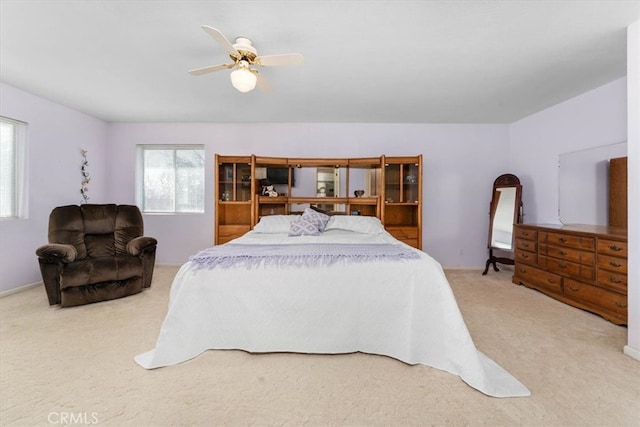 carpeted bedroom with a ceiling fan