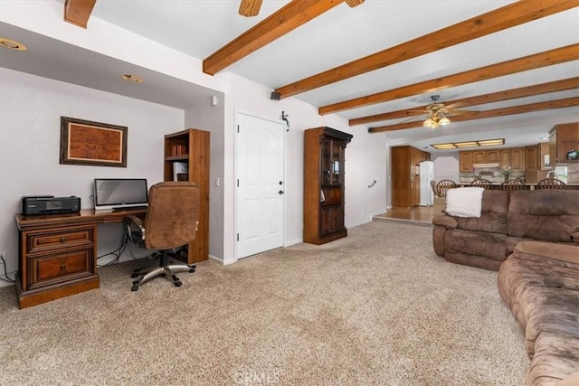 living area with beamed ceiling, light carpet, and a ceiling fan