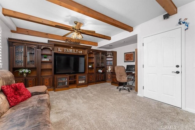 living room with beam ceiling, a ceiling fan, and carpet flooring