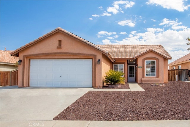 ranch-style house with a tile roof, fence, driveway, and stucco siding