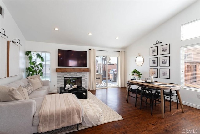 living area with a fireplace, lofted ceiling, recessed lighting, and dark wood-style floors