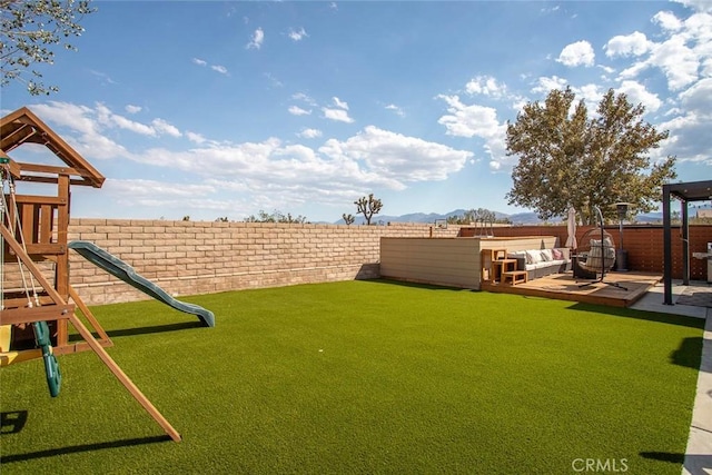 view of yard featuring a playground and a fenced backyard