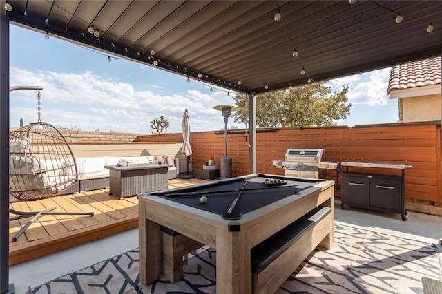 view of patio / terrace with a grill and fence