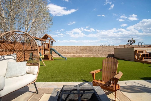 view of yard with a fenced backyard and a playground