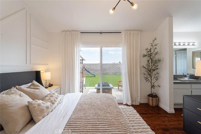 bedroom featuring baseboards, access to exterior, and dark wood finished floors