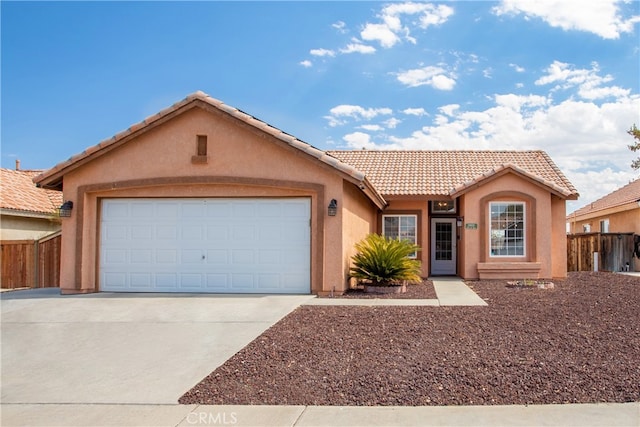 ranch-style home with stucco siding, fence, concrete driveway, and a tiled roof