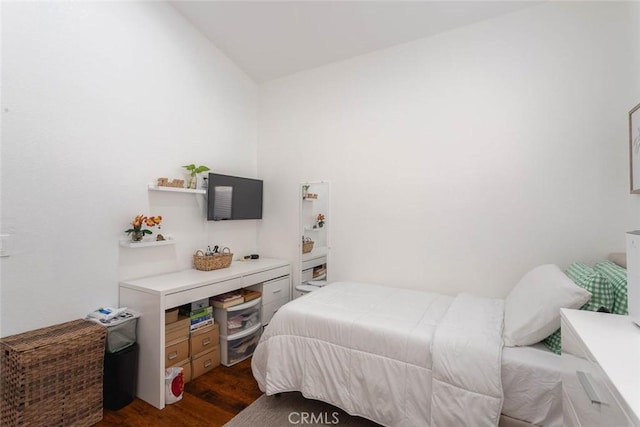 bedroom with dark wood-type flooring