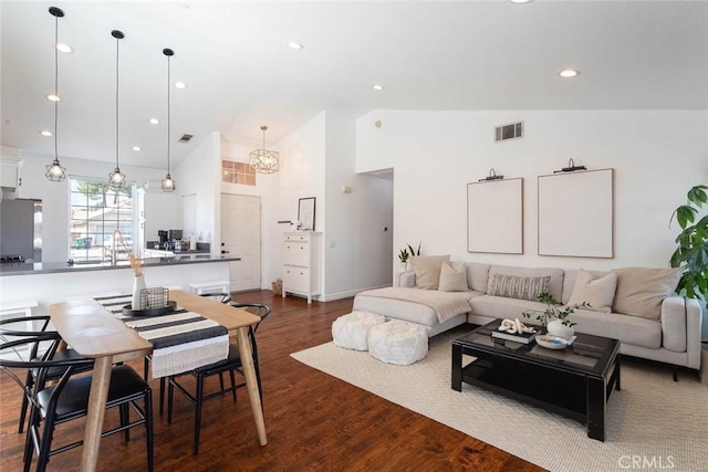 living area featuring recessed lighting, visible vents, high vaulted ceiling, and dark wood-style floors