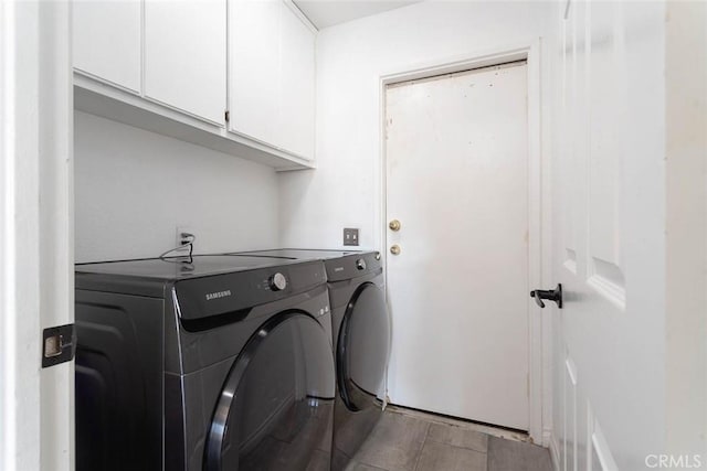 clothes washing area with cabinet space, washing machine and dryer, and wood tiled floor