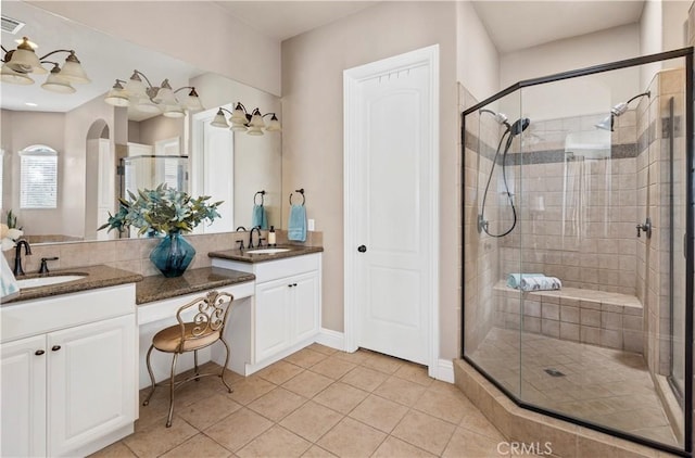 bathroom with a shower stall and a sink