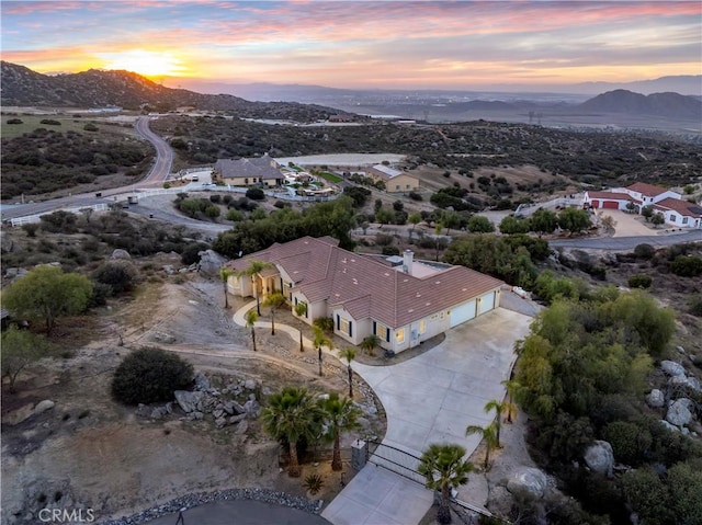 aerial view at dusk featuring a mountain view