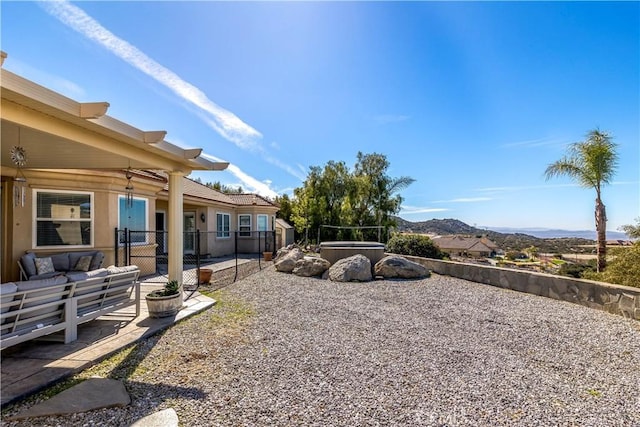 view of yard featuring a patio, fence, and a mountain view