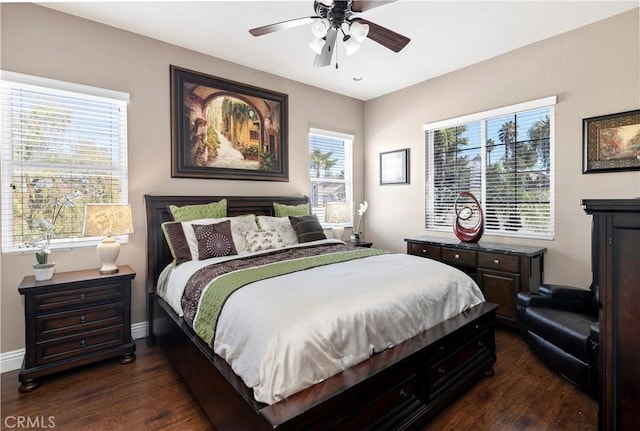 bedroom featuring dark wood finished floors, a ceiling fan, and baseboards