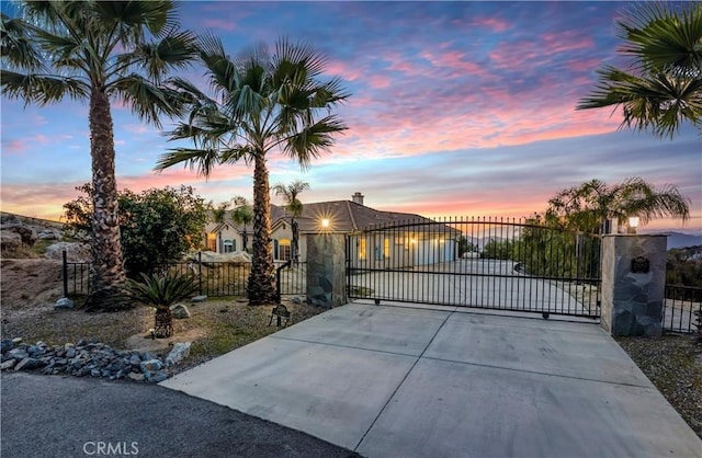 view of gate with a fenced front yard