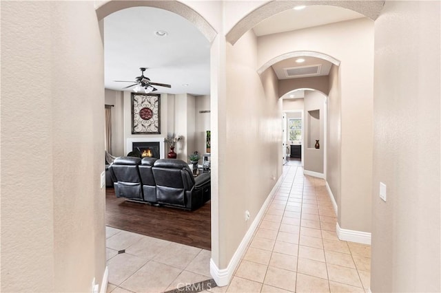 hallway featuring light tile patterned flooring, visible vents, recessed lighting, and baseboards