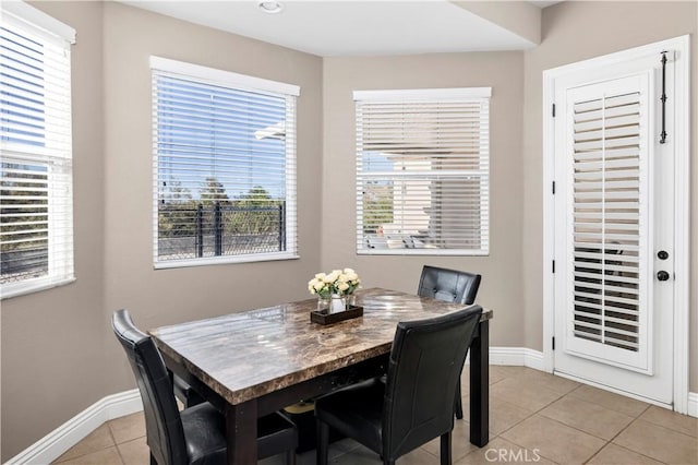 dining room with baseboards and light tile patterned flooring