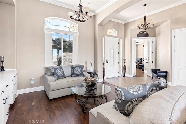 living room featuring ornamental molding, dark wood-style floors, arched walkways, an inviting chandelier, and baseboards