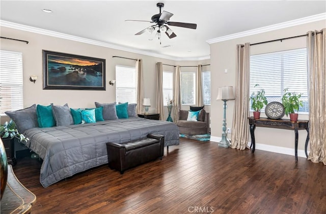 bedroom featuring a ceiling fan, crown molding, baseboards, and wood finished floors