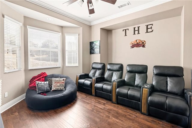 home theater room with visible vents, a healthy amount of sunlight, wood finished floors, and a ceiling fan