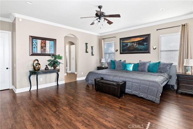 bedroom with arched walkways, ornamental molding, baseboards, and wood finished floors