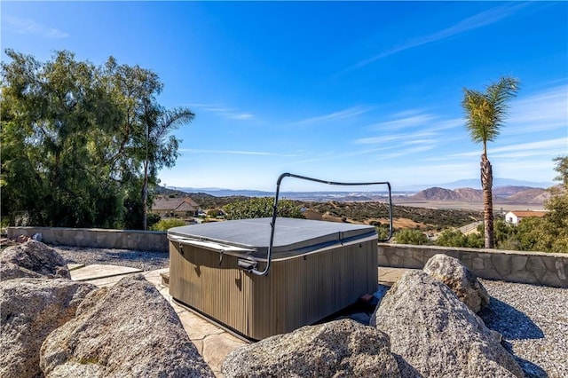 view of yard featuring a mountain view and a hot tub