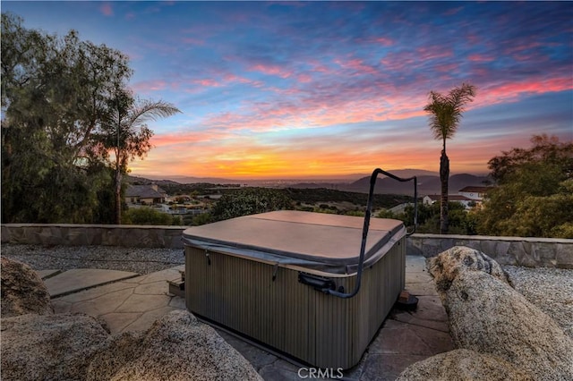 patio terrace at dusk with a hot tub