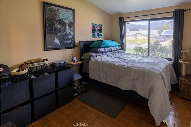 bedroom featuring vaulted ceiling and wood finished floors