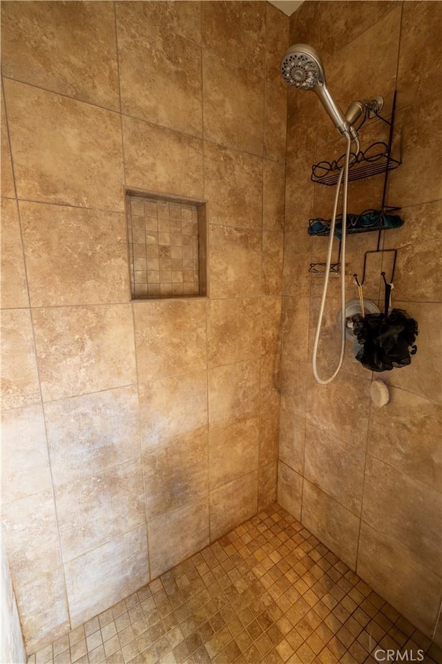 bathroom with tiled shower