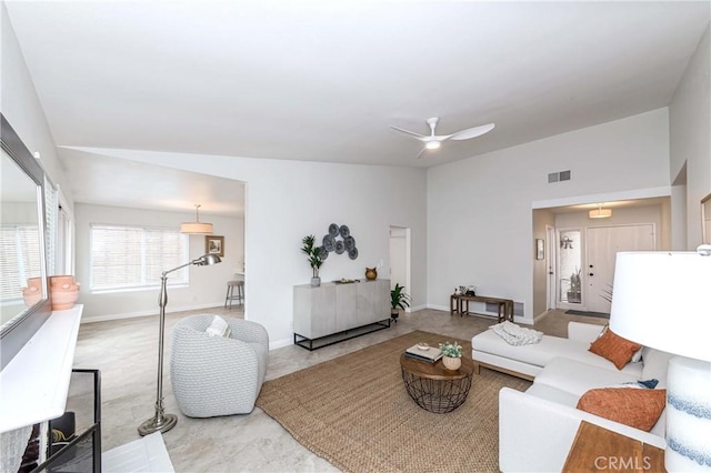 living area with visible vents, baseboards, a ceiling fan, and vaulted ceiling