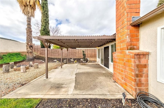 view of patio featuring a pergola and fence