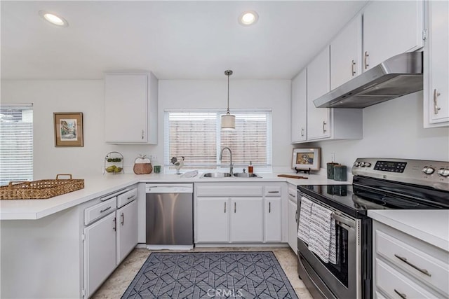 kitchen featuring under cabinet range hood, a sink, appliances with stainless steel finishes, a peninsula, and light countertops