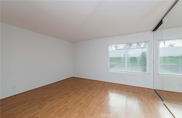 unfurnished room with light wood-type flooring