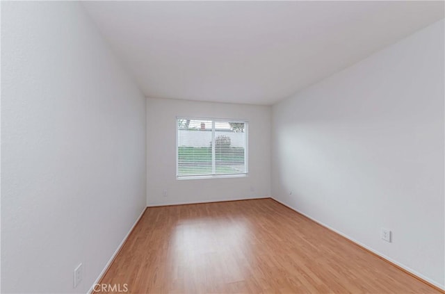 unfurnished room with light wood-style flooring