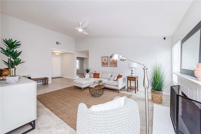 living room with visible vents, lofted ceiling, baseboards, a brick fireplace, and ceiling fan