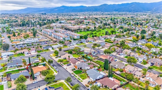 drone / aerial view featuring a residential view and a mountain view