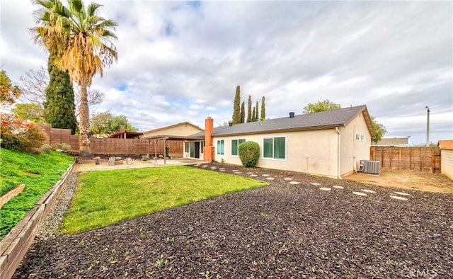 back of house featuring stucco siding, cooling unit, a yard, a fenced backyard, and a patio area