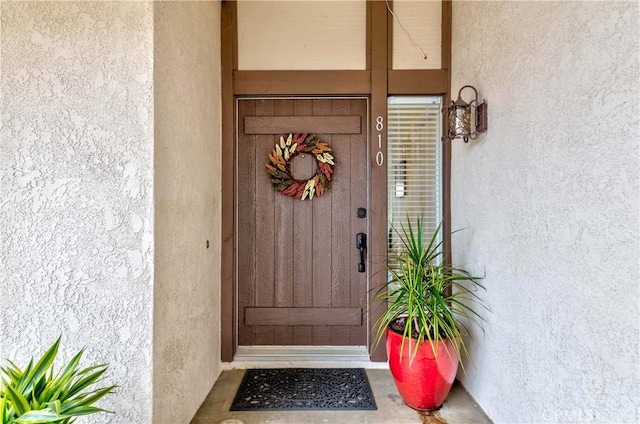 property entrance featuring stucco siding