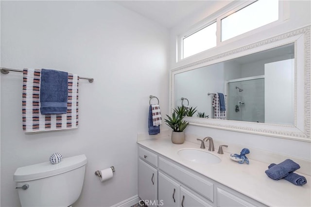 bathroom featuring vanity, toilet, and a stall shower