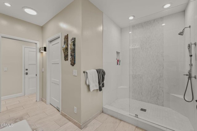 bathroom featuring a tile shower, recessed lighting, baseboards, and wood tiled floor