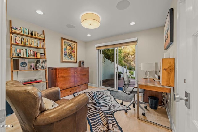 living area with recessed lighting, baseboards, and wood finished floors