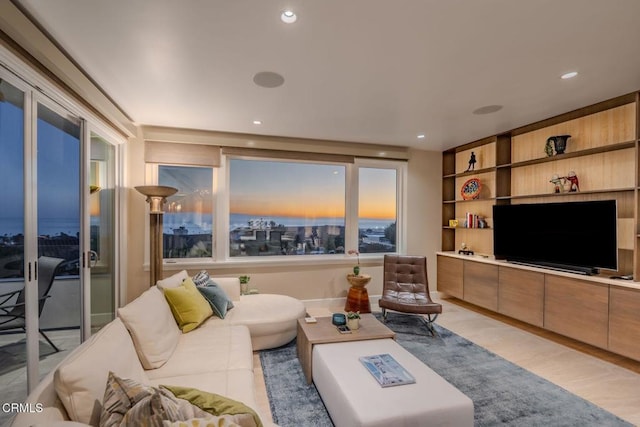 living area with light wood finished floors and recessed lighting