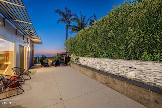 view of patio terrace at dusk