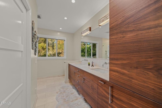 bathroom with visible vents, a sink, recessed lighting, tile patterned flooring, and double vanity